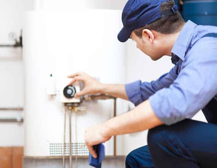 technician-works-on-water-heater-maintenance